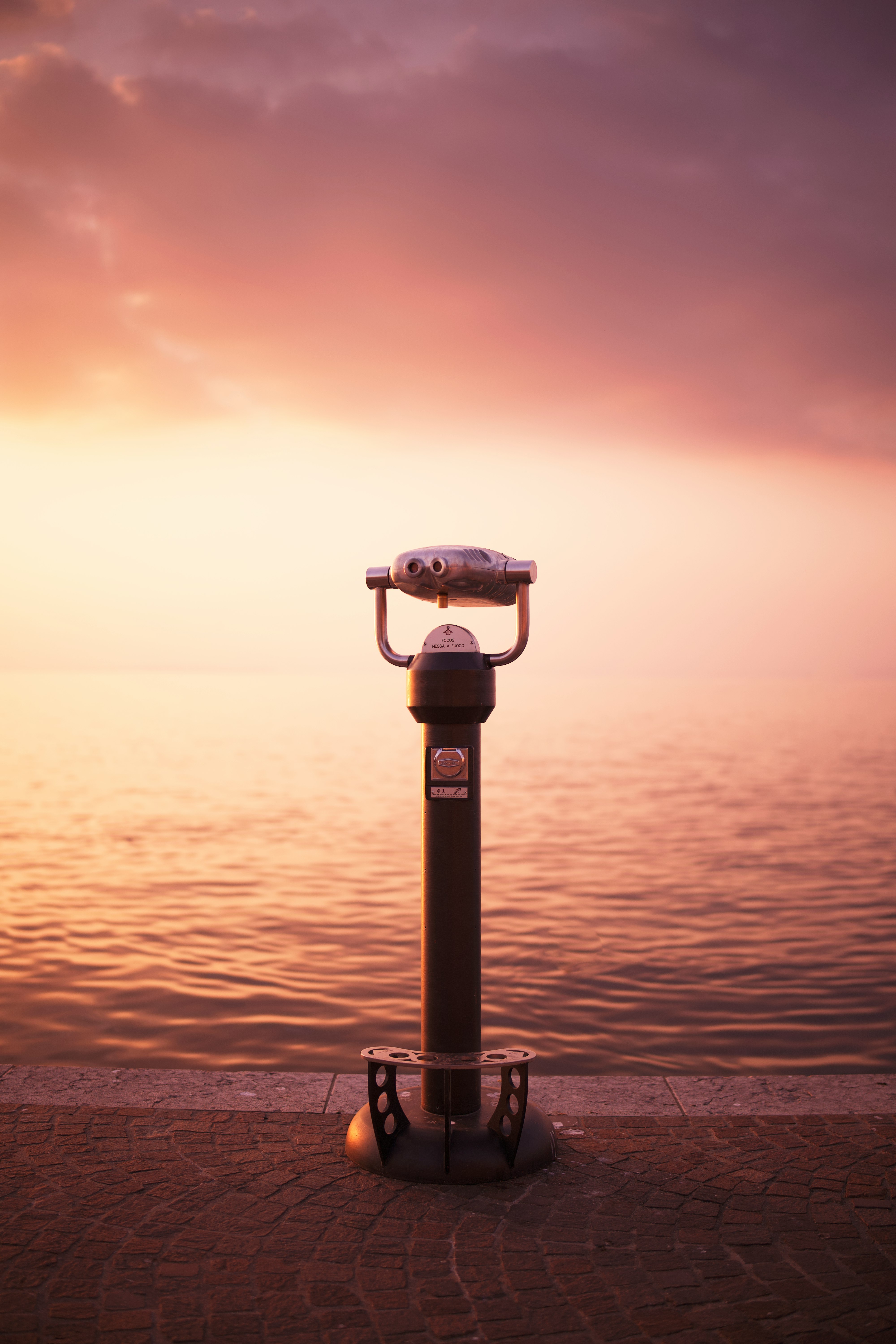 black and gray binoculars on top of the building during sunset